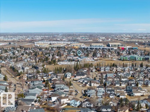 Aerial view of the surrounding neighborhood, featuring residential homes with various roof styles and a clear blue sky - 3772 30 Street, Edmonton, AB - Outdoor With View