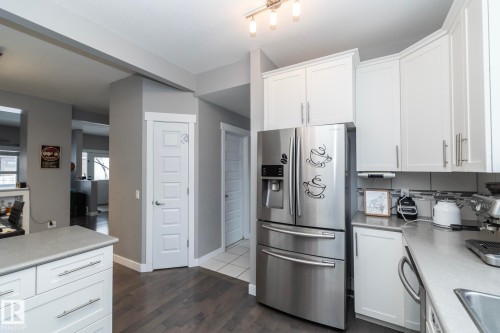 Kitchen featuring white cabinetry, light-colored countertops, and hardwood flooring - 7359 179 Avenue, Edmonton, AB - Indoor Photo Showing Kitchen