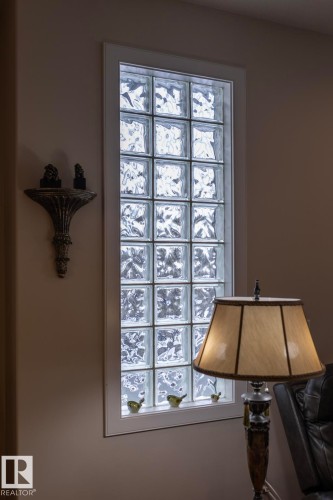A tall glass block window with a white frame provides natural light - 307 Ravine Close, Devon, AB - Indoor