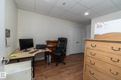 This room features light-colored walls and wood flooring, offering a versatile space - 