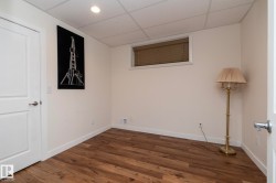 This room features wood plank flooring, a single window with blinds, and recessed lighting - 