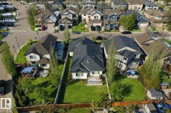 This property features a spacious backyard with a well-maintained lawn and mature trees - 