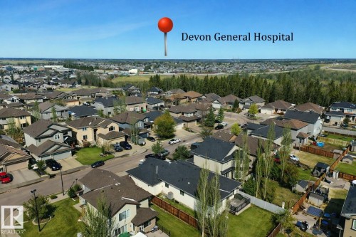 Aerial view showcasing the property within a residential community, featuring numerous homes with diverse architectural styles and well-maintained yards - 307 Ravine Close, Devon, AB - Outdoor With View