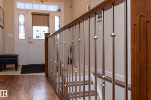 The entryway features a wooden floor and a white door with glass panels - 307 Ravine Close, Devon, AB - Indoor Photo Showing Other Room