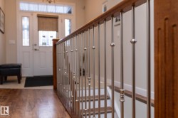 The entryway features a wooden floor and a white door with glass panels - 