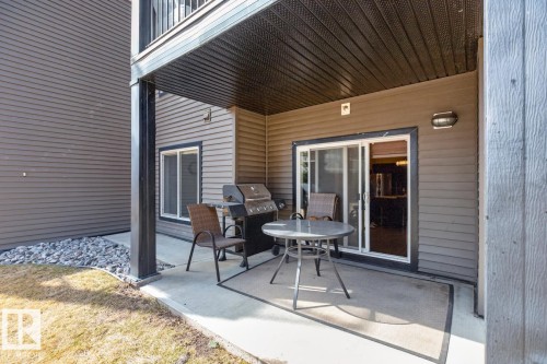 The property features a concrete patio area with a covered ceiling, providing an ideal space for outdoor enjoyment - 109 340 Windermere Road, Edmonton, AB 