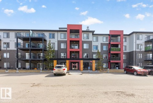 The property features a modern exterior with a multi-story design and a color palette of white, gray, and red accents - 109 340 Windermere Road, Edmonton, AB 