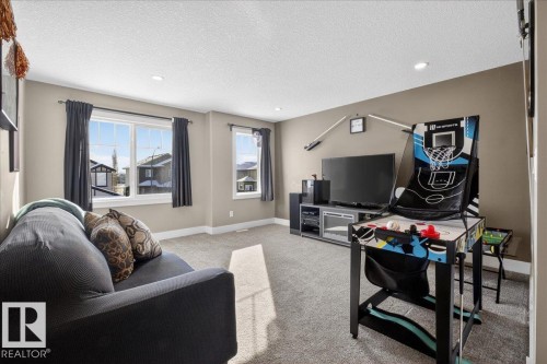Living area featuring neutral wall tones, carpeted flooring, and recessed lighting - 606 Reynalds Way, Leduc, AB - Indoor Photo Showing Living Room
