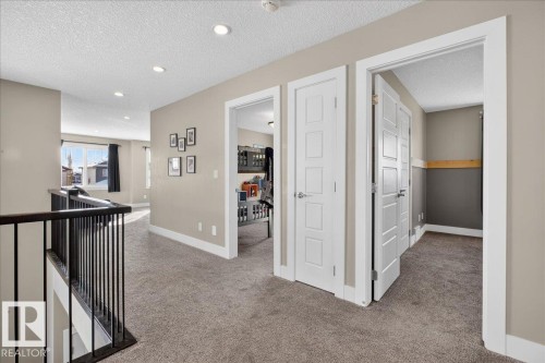 The interior features neutral-toned walls, recessed lighting, and carpeted flooring - 606 Reynalds Way, Leduc, AB - Indoor Photo Showing Other Room