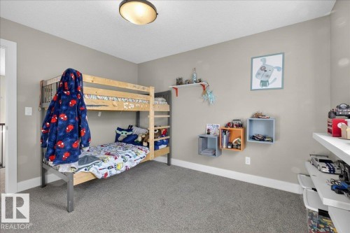Room with light grey walls and grey carpet flooring - 606 Reynalds Way, Leduc, AB - Indoor Photo Showing Bedroom