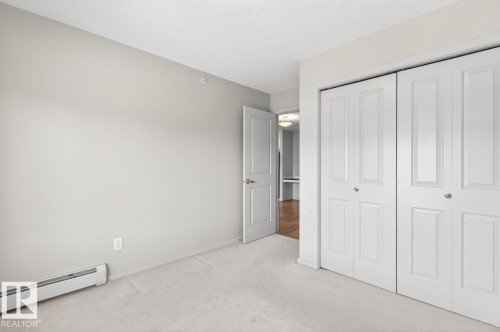 This room features light gray walls, white trim, and light-colored carpeting - 426 390 Windermere Road, Edmonton, AB - Indoor