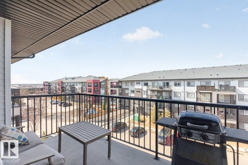 The property features a concrete balcony with a black metal railing - 426 390 Windermere Road, Edmonton, AB - Outdoor With Balcony With Exterior
