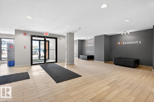 The property features a bright entrance area with light-toned flooring, recessed lighting, and large glass doors - 426 390 Windermere Road, Edmonton, AB - Indoor Photo Showing Other Room