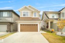 The property features a two-story exterior with a two-car garage and a paved driveway - Edmonton, AB  - Outdoor With Facade 