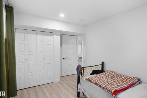 This room features light-colored flooring, white walls, and recessed lighting - Edmonton, AB - Indoor Photo Showing Bedroom