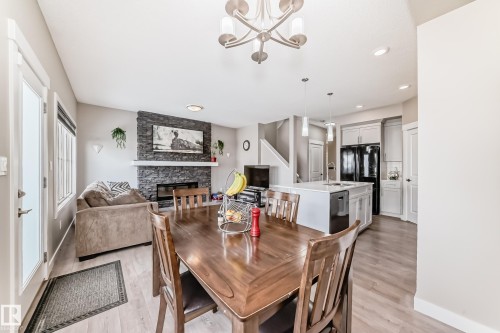 48 Gladstone Bend, Spruce Grove, AB - Indoor Photo Showing Dining Room With Fireplace