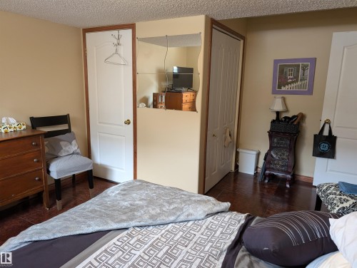 This room features light-colored walls and dark flooring - 65 Coloniale Way, Beaumont, AB - Indoor Photo Showing Bedroom