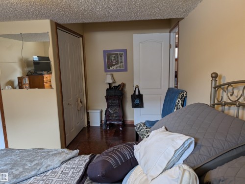This room features light-colored walls and a textured ceiling - 65 Coloniale Way, Beaumont, AB - Indoor Photo Showing Bedroom