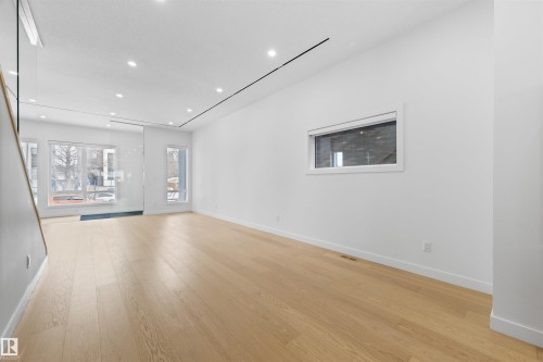 Spacious living area featuring light wood flooring and recessed lighting - 14037 104 Avenue, Edmonton, AB - Indoor Photo Showing Other Room