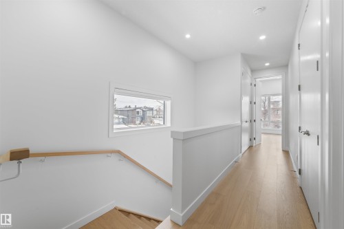 A bright hallway with light-colored hardwood floors and recessed lighting - 14037 104 Avenue, Edmonton, AB - Indoor Photo Showing Other Room