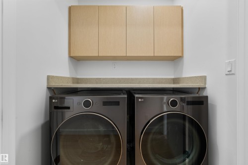 Dedicated laundry area featuring modern appliances, a countertop, and light wood cabinetry for storage - 14037 104 Avenue, Edmonton, AB - Indoor Photo Showing Laundry Room