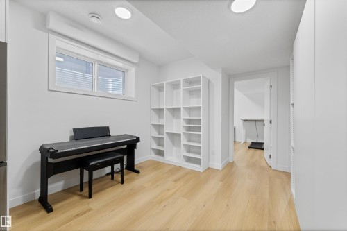This versatile space features light-toned flooring, white walls, and a window providing natural illumination - 14037 104 Avenue, Edmonton, AB - Indoor Photo Showing Other Room