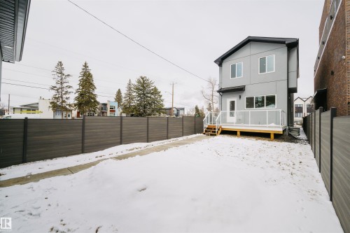 The property features a private deck with a glass railing, accessed by stairs - 14037 104 Avenue, Edmonton, AB - Outdoor With Exterior
