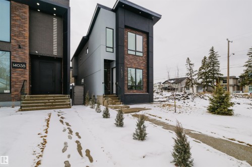 The property features a modern exterior with a grey facade, brick accents, and large windows - 14037 104 Avenue, Edmonton, AB - Outdoor