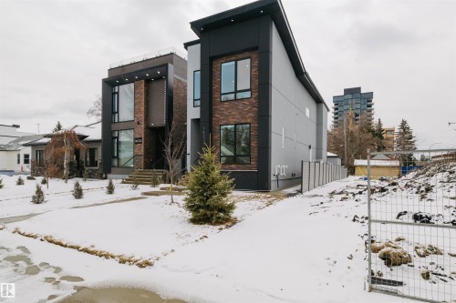 The property features a contemporary architectural style with a dark facade and brick accents - 14037 104 Avenue, Edmonton, AB - Outdoor