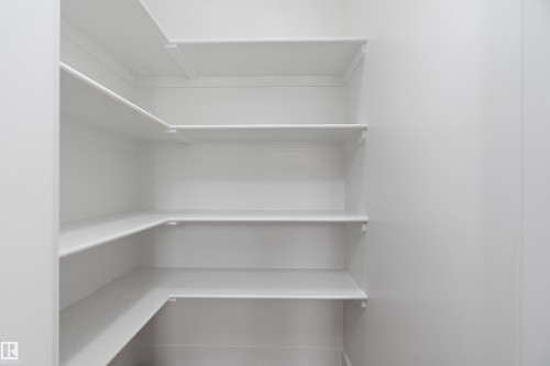 The property features extensive built-in shelving, providing generous storage solutions - 219 Crystal Creek Dr, Leduc, AB - Indoor With Storage