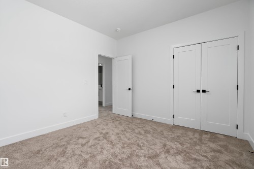 This room features neutral-toned carpeting, white walls, and white trim - 219 Crystal Creek Dr, Leduc, AB - Indoor Photo Showing Other Room