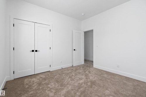 This room features white walls, light brown carpet, and white trim - 219 Crystal Creek Dr, Leduc, AB - Indoor Photo Showing Other Room