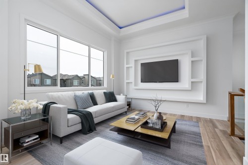 Living room featuring large windows, a built-in media center with shelving, and light-colored flooring - 219 Crystal Creek Dr, Leduc, AB - Indoor Photo Showing Living Room