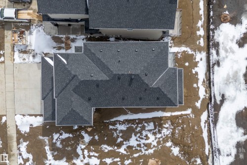 The property features a dark grey shingle roof with multiple gables - 219 Crystal Creek Dr, Leduc, AB - Outdoor