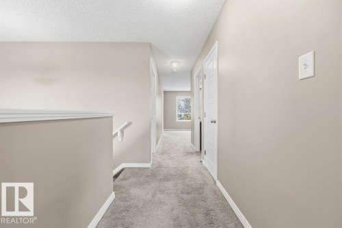 Hallway with light-colored walls, white trim, and carpeted flooring - 7873 170A Avenue, Edmonton, AB - Indoor Photo Showing Other Room