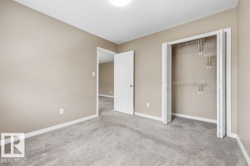 Room featuring neutral-toned walls, grey carpeting, and white trim - 7873 170A Avenue, Edmonton, AB - Indoor