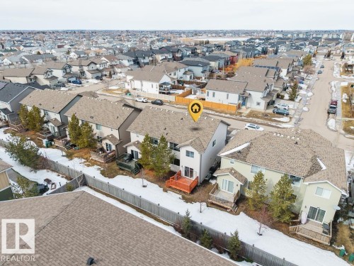 Aerial overview of a developed urban landscape featuring a prominent commercial building with multi-colored facade elements - 7873 170A Avenue, Edmonton, AB - Outdoor With View