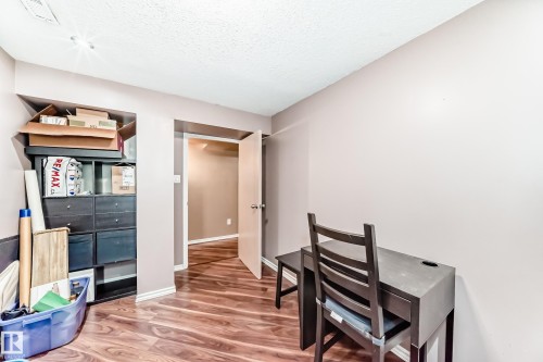 The room features a textured ceiling, recessed lighting, and wood-look flooring - 7512 136 Avenue, Edmonton, AB - Indoor Photo Showing Other Room