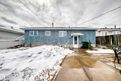 The property features a concrete patio with a white back door, complemented by a white awning - 7512 136 Avenue, Edmonton, AB - Outdoor
