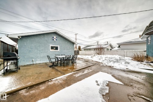 The property features a concrete patio area, ideal for outdoor entertaining - 7512 136 Avenue, Edmonton, AB - Outdoor