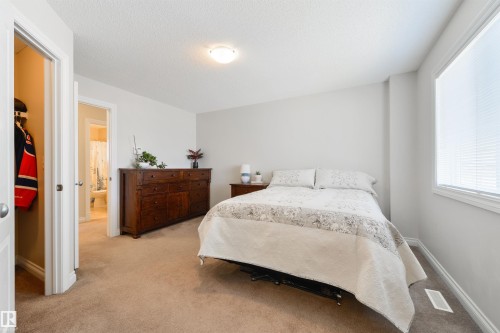 This room features light-colored walls, carpeted flooring, and a window with blinds providing natural light - 67 12050 17 Avenue, Edmonton, AB - Indoor Photo Showing Bedroom