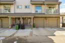 The property features a multi-level design with light-colored siding and a covered entrance - 67 12050 17 Avenue, Edmonton, AB  - Outdoor With Balcony With Facade 