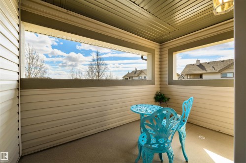 The property features an outdoor patio with a paneled ceiling and a view of the surrounding neighborhood - 67 12050 17 Avenue, Edmonton, AB - Outdoor With Deck Patio Veranda With Exterior