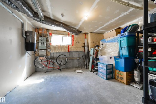 The unfinished room features a concrete floor and exposed ceiling with ductwork - 67 12050 17 Avenue, Edmonton, AB - Indoor Photo Showing Garage