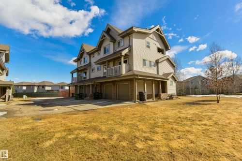 The property features a multi-story exterior with light-colored siding, a pitched roof, and several balconies - 67 12050 17 Avenue, Edmonton, AB - Outdoor