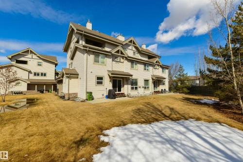 The property features a large yard with a patio area and direct access to the outdoors through a sliding glass door - 67 12050 17 Avenue, Edmonton, AB - Outdoor