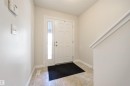 The property features an entryway with tiled flooring and a white front door with a sidelight, providing natural light - 67 12050 17 Avenue, Edmonton, AB  - Indoor Photo Showing Other Room 