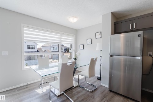 This inviting space features a large window, providing natural light, and durable wood-look flooring - 17268 9B Avenue, Edmonton, AB 