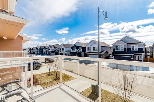The property features a balcony with glass railings, offering views of the street and surrounding homes - 17268 9B Avenue, Edmonton, AB 
