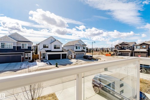 View of the surrounding streetscape featuring residential properties and a clear sky - 17268 9B Avenue, Edmonton, AB 